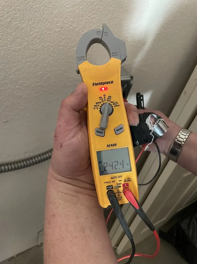 Voltage testing with clamp meter during Outlet Installation in Rochester Hills